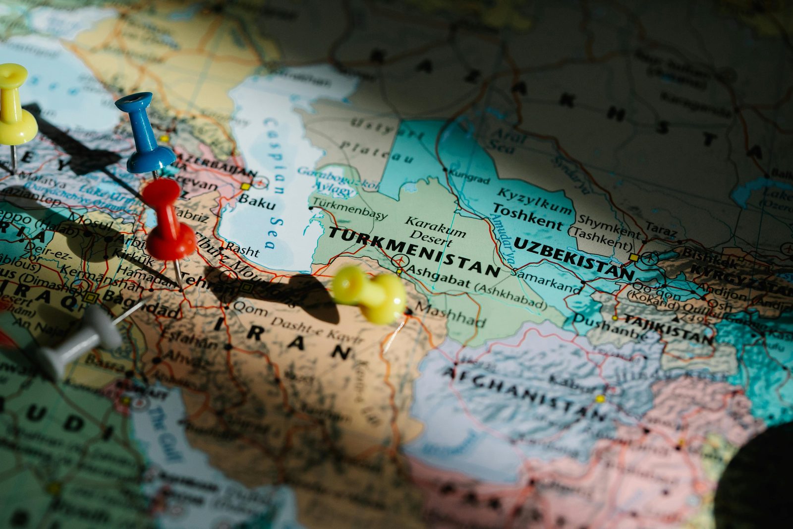 World map marked with coloured pushpins across multiple countries